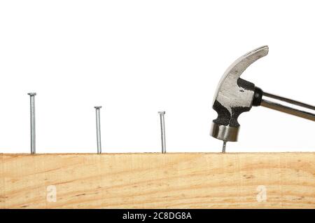 consecutive nails on wood and hammer Stock Photo