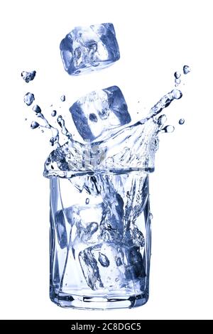ice cubes falling into a glass of water on a blue background Stock ...