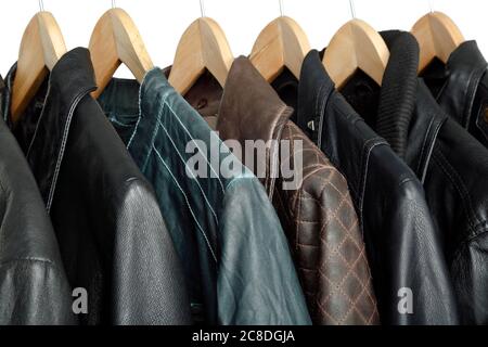 collection of leather jackets on hangers Stock Photo