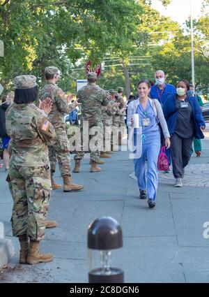 Soldiers and Airmen of the Mississippi National Guard gather at the entrance to the University of Mississippi Medical Center to honor civilian healthcare workers during National Nurses Week in Jackson, Miss., May 6, 2020.  The Guardsmen cheered for UMMC employees as they entered and exited the hospital during morning shift change and thanked them for their work during the COVID-19 pandemic.  (U.S. Army National Guard photo by Spc. Jovi Prevot)