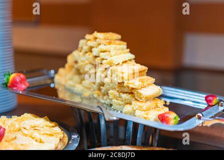 Egyptian semolina cake with almonds and syrup. Eastern cookies Basbousa -beautifully served on metal plate. Traditional desert in Egypt Stock Photo