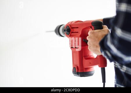 Close-up of man using electric drill Stock Photo