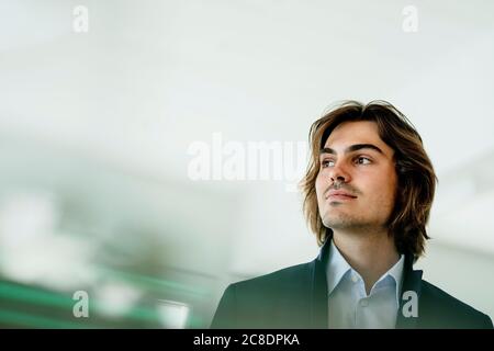 Close-up of thoughtful male entrepreneur looking away in cafe Stock Photo