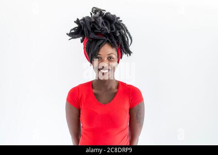 Portrait of young woman with dreadlocks wearing red t-shirt