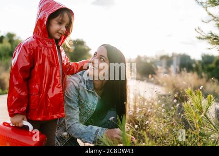 Mother and daughter picking wild flowers Stock Photo