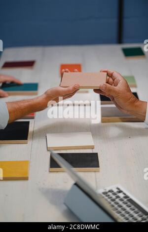 Hands of architects choosing colour samples in office Stock Photo
