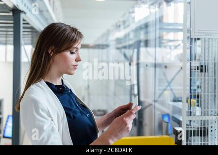 Close-up of businesswoman using digital tablet in factory Stock Photo