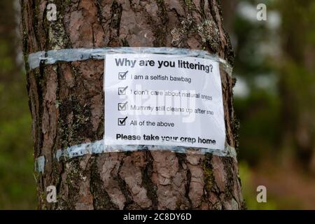 Litter problems constant problem in Loch Lomond and the Trossachs National Park during coronavirus pandemic - sign by Loch Chon asking why - Scotland Stock Photo