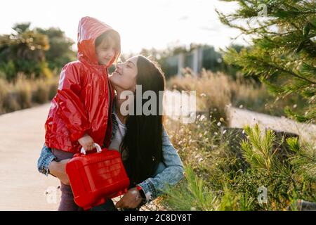 Mother and daughter picking wild flowers Stock Photo