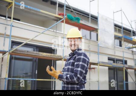 Portrait of a laughing worker on a construction site