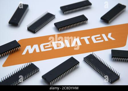 Stone / United Kingdom - July 23, 2020: Mediatek semiconductor chip manufacturer company logo seen on the paper and microchips placed around. Selectiv Stock Photo