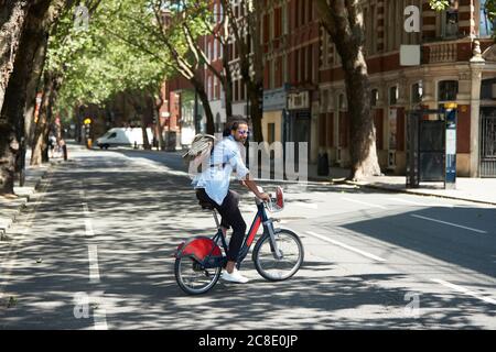 Young man using rental bike in the city, London, UK Stock Photo
