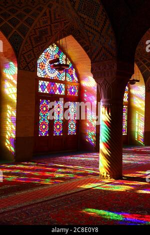 Iran, Fars Province, Shiraz, Sunlight illuminating interior of Nasir-ol-Molk Mosque through colorful stained glass windows Stock Photo