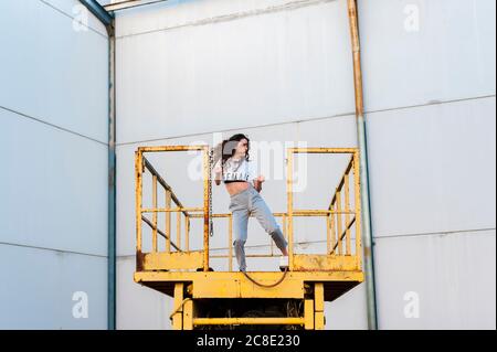 Female hip-hop dancer dancing on metallic platform in abandoned building Stock Photo