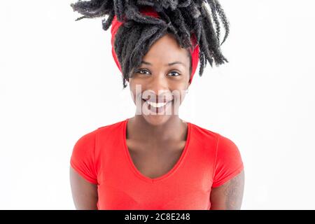 Portrait of young woman with dreadlocks wearing red t-shirt