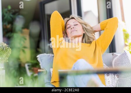 Portrait of mature woman with eyes closed relaxing in hammock on Stock ...