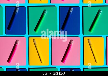 Pattern of colorful notebooks and matching felt tip pens Stock Photo