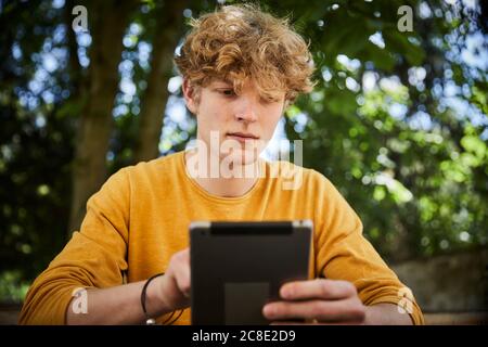 Portrait of young man using digital tablet outdoors Stock Photo