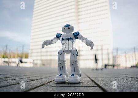 Mini robot on a square in the city Stock Photo