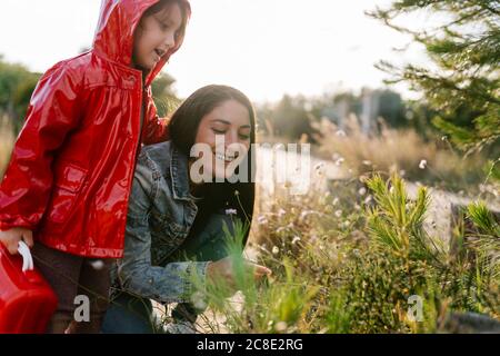 Mother and daughter picking wild flowers Stock Photo