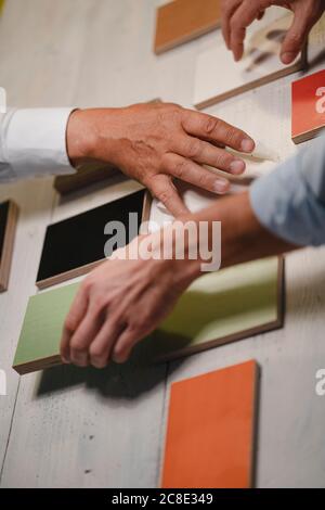 Hands of architects choosing colour samples in office Stock Photo