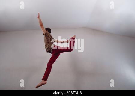 Artistic modern dancer practicing dancing moves in the studio Stock Photo