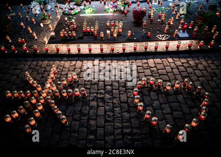 Duisburg, Germany. 23rd July, 2020. Candles are at the memorial. Before the 10th anniversary of the mass panic at the Love Parade, in which 21 people die, the 'Night of 1000 Lights' takes place. In silent remembrance of the victims of the Love Parade disaster, people light candles at the memorial and the tunnel on Karl-Lehr-Strasse on the eve of the anniversary. Credit: Fabian Strauch/dpa/Alamy Live News Stock Photo