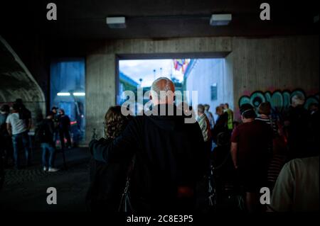 Duisburg, Germany. 23rd July, 2020. People stand in front of the entrance to the memorial. Before the 10th anniversary of the mass panic at the Love Parade, in which 21 people die, the 'Night of 1000 Lights' takes place. In silent remembrance of the victims of the Love Parade disaster, people light candles at the memorial and the tunnel on Karl-Lehr-Strasse on the eve of the anniversary. Credit: Fabian Strauch/dpa/Alamy Live News Stock Photo