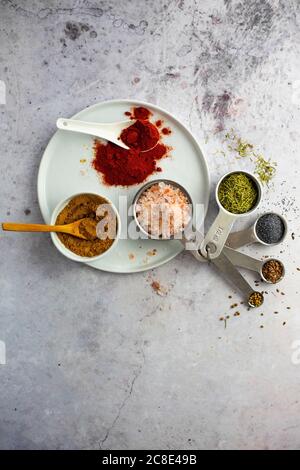 Curry powder, paprika, pink salt, rosemary, poppy seeds, flax seeds, coriander seeds Stock Photo