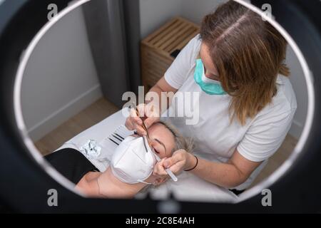Female beautician giving beauty treatment to customer at spa Stock Photo