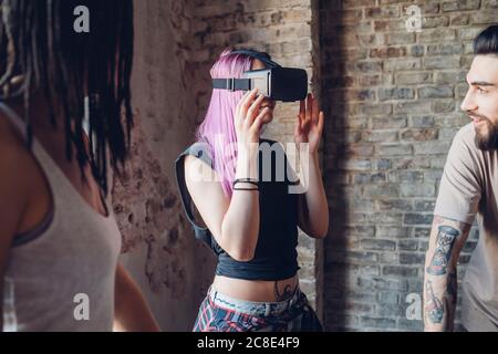 Creative team using Vr goggles in loft office Stock Photo