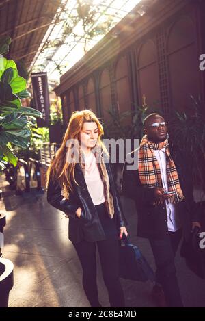 Stylish business people walking on footpath Stock Photo