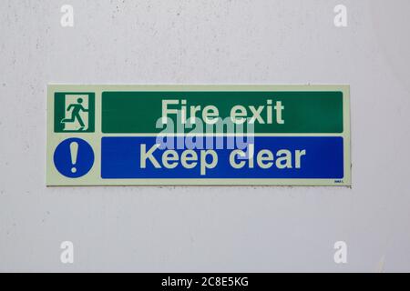 a fire exit keep clear sign on the front of a fire escape door Stock Photo