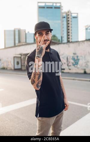 Portrait of a stylish young man posing on the street in the city Stock Photo