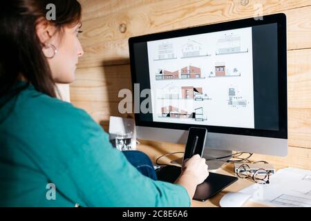 Female architect using computer at home Stock Photo