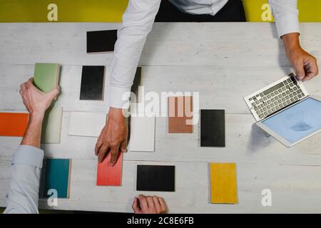 Hands of architects choosing colour samples in office Stock Photo