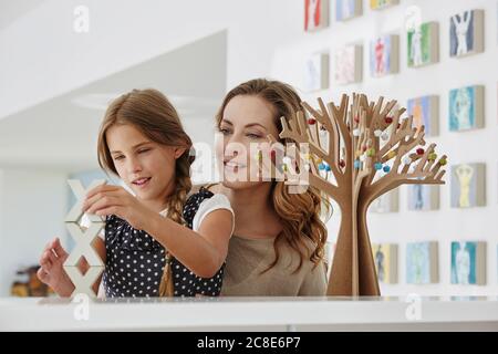 Mother and daughter doing handicraft at home Stock Photo