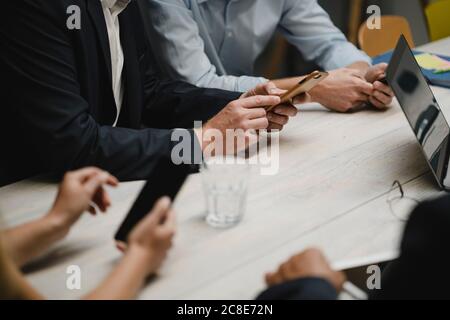 Business people working in office using portable devices, close up Stock Photo
