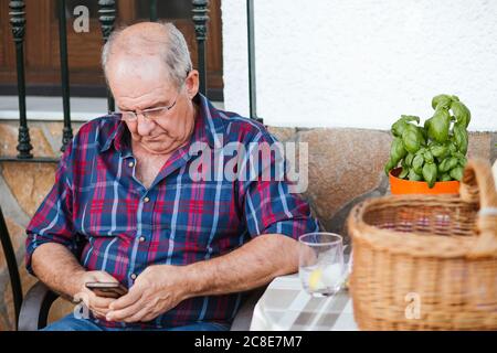 Senior man using smartphone Stock Photo