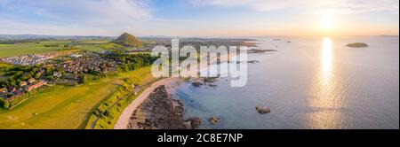 UK, Scotland, North Berwick, Aerial panorama of coastal town at summer sunset