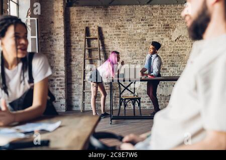 Creative team talking in loft office Stock Photo