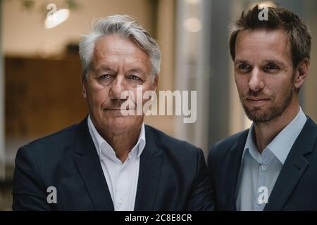 Portrait of two businessmen, looking at distance Stock Photo