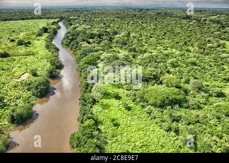 Democratic Republic of Congo, Aerial view of Garamba River flowing through green savannah in Garamba National Park Stock Photo