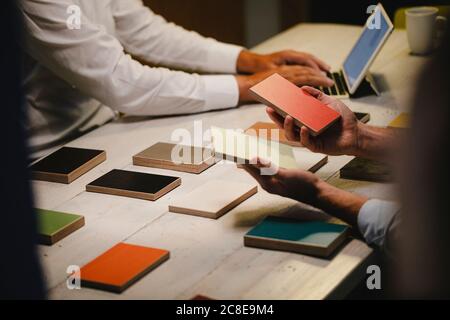 Hands of architects choosing colour samples in office Stock Photo