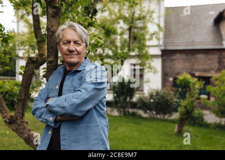 Portrait of a confident senior man standing in a rural garden Stock Photo