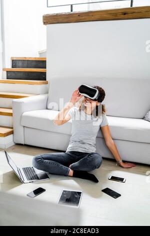 Woman sitting on the floor experiencing laptop problems Stock Photo - Alamy