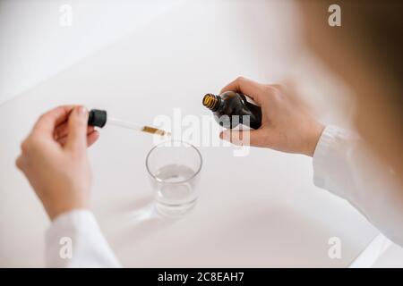 Female doctor preparing tincture Stock Photo