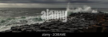 Waves crashing on the Giant's Causeway, Causeway Coast, County Antrim, Northern Ireland Stock Photo