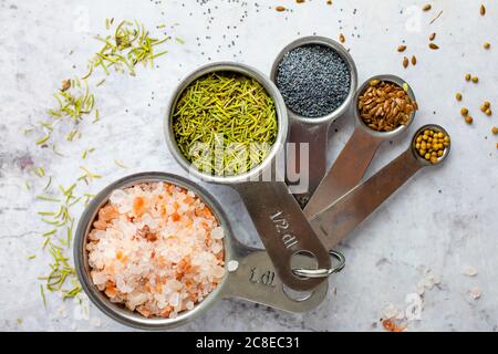 Pink salt, rosemary, poppy seeds, flax seeds, coriander seeds Stock Photo