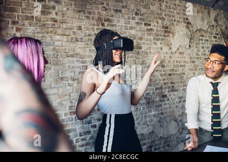 Creative team using Vr goggles in loft office Stock Photo